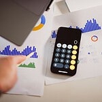 Calculator and laptop for planning a small business SEO and Google Ads budget