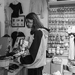 Small business owner working through an SEO checklist at the shop counter